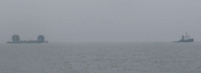 Tug towing cable barge