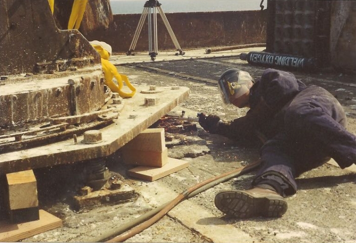 Royal Engineer acetylene cutting the 3.7" Gun fixing bolts
